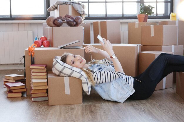 Woman finished with cargo packages and is checking her phone