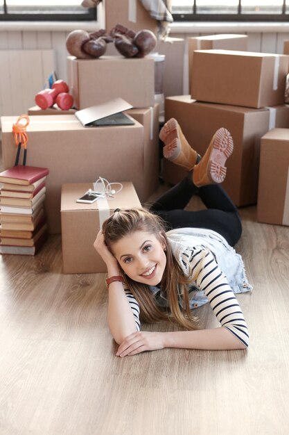 Woman finished with cargo packages and is lying on the floor