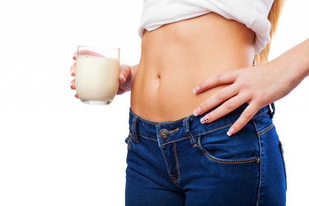 Woman flat belly with glass of milk