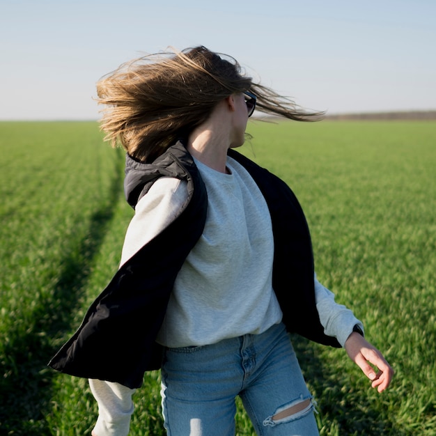 Woman flipping her head in the field