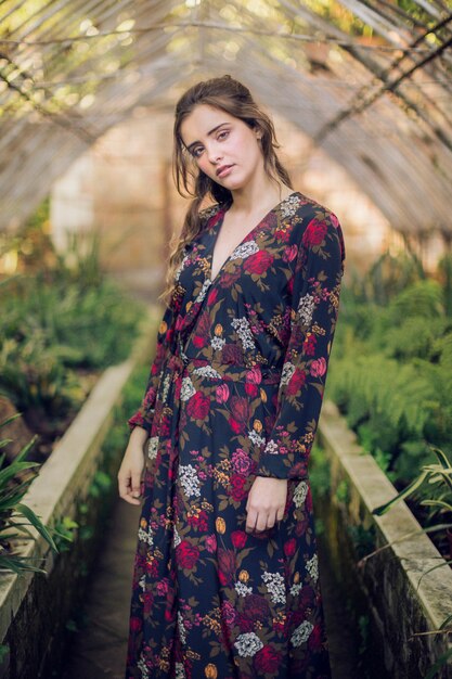Woman in floral dress looking at camera