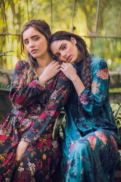 Woman in floral dresses sitting on a bench