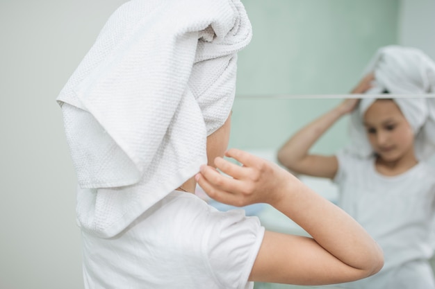 Woman in front of mirror in bathroom