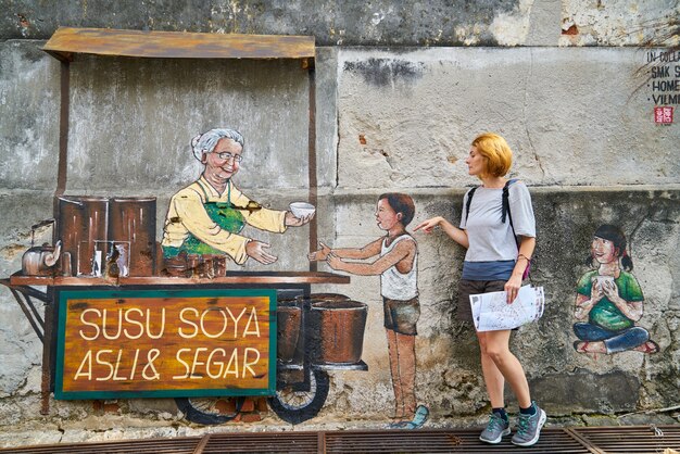 Woman in front of a store graffiti