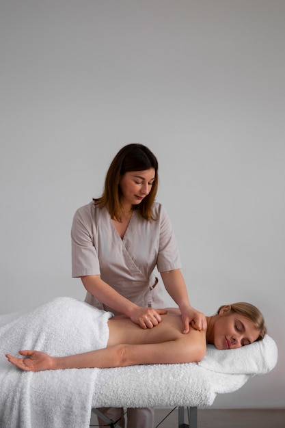 Woman getting a back massage from masseur