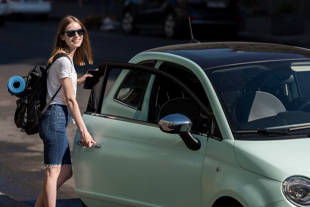 Woman getting in car for voyage