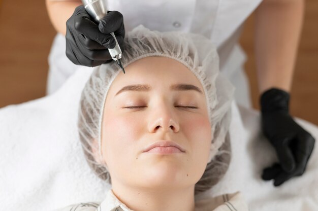 Woman getting an eyebrow treatment at the beauty salon