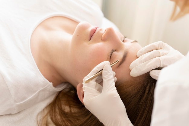 Woman getting an eyebrow treatment