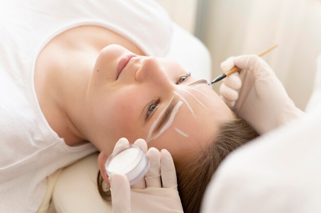 Woman getting an eyebrow treatment