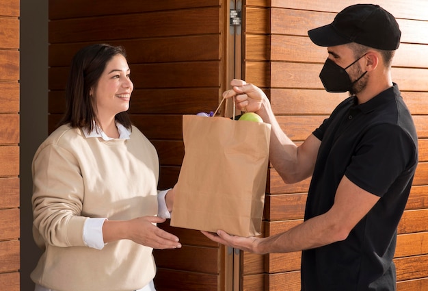 Woman getting a food bag delivered