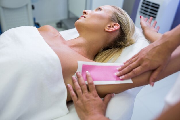 Woman getting her armpit hair removed