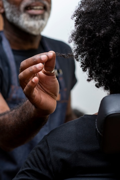 Free photo woman getting her hair done at the salon by male hairdresser