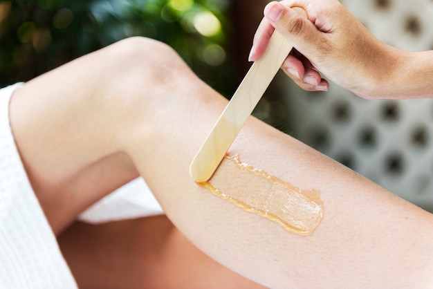 Free photo woman getting legs waxed at a spa