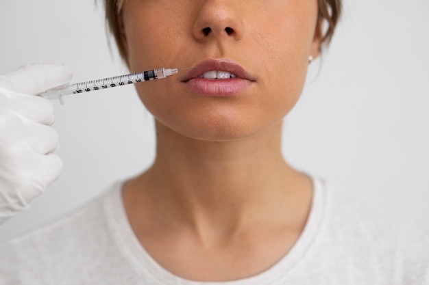 Free photo woman getting lip filler close up