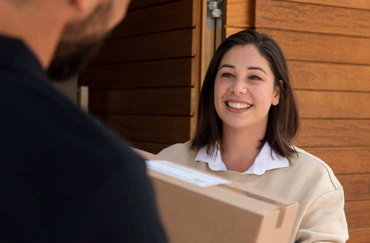 Free Photo woman getting a package delivered