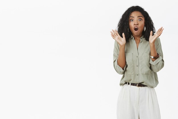 Woman getting shocked being scared of sudden noise.