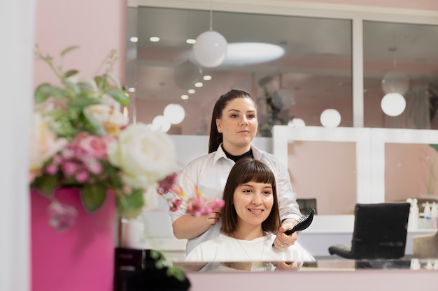 Woman getting treatment at hairdresser shop