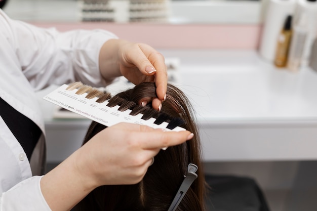 Woman getting treatment at hairdresser shop