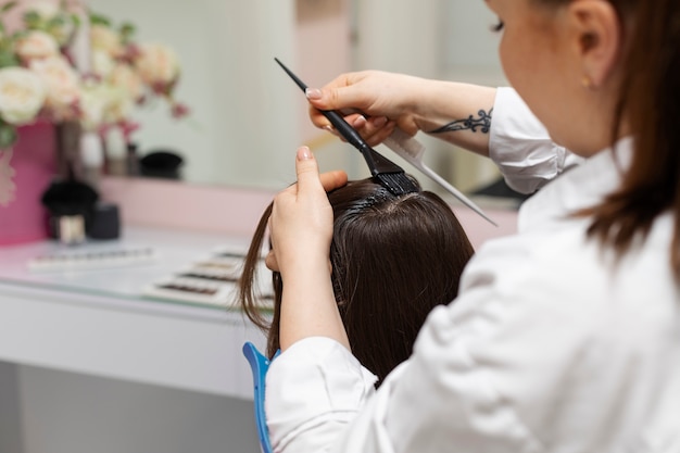 Woman getting treatment at hairdresser shop