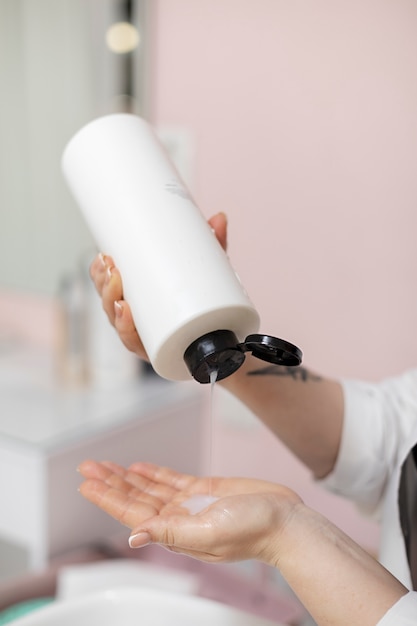 Woman getting treatment at hairdresser shop