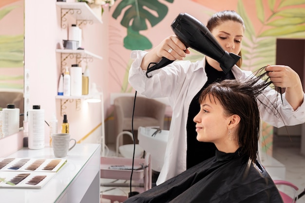 Woman getting treatment at hairdresser shop