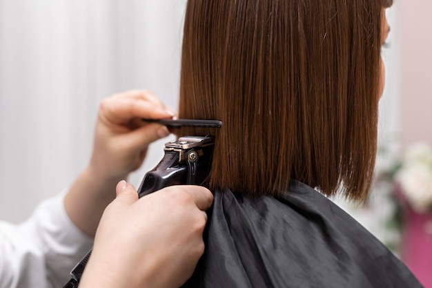 Woman getting treatment at hairdresser shop