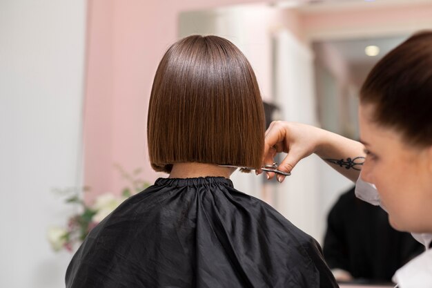 Woman getting treatment at hairdresser shop