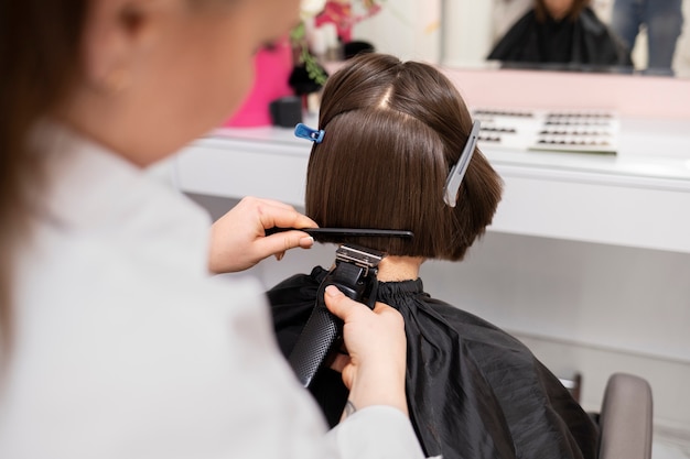 Woman getting treatment at hairdresser shop