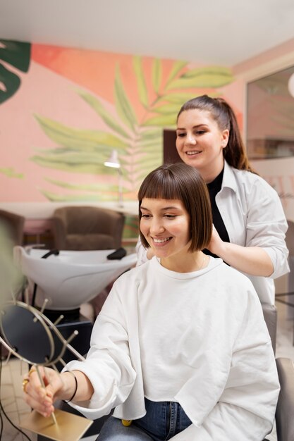 Woman getting treatment at hairdresser shop