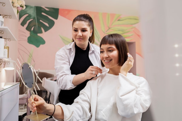 Woman getting treatment at hairdresser shop