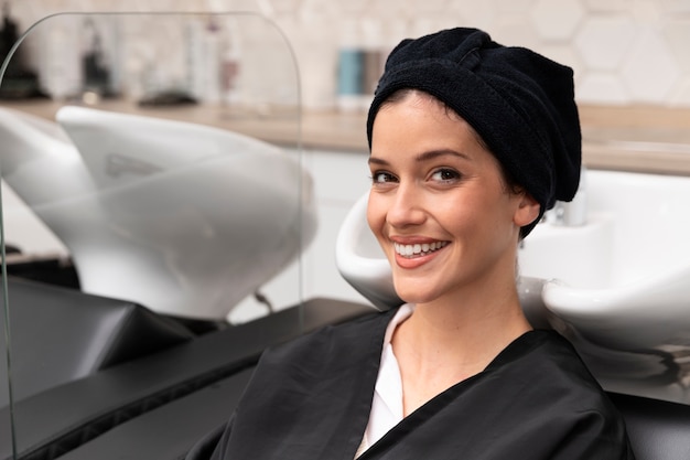 Woman getting treatment at hairdresser shop