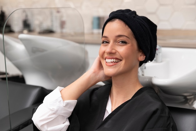 Woman getting treatment at hairdresser shop