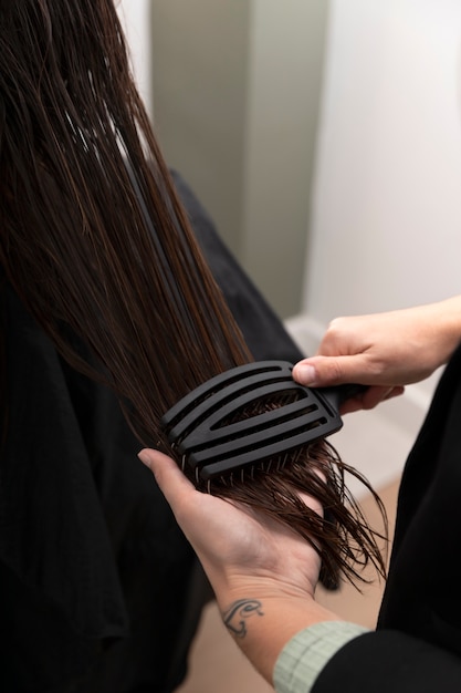 Woman getting treatment at hairdresser shop