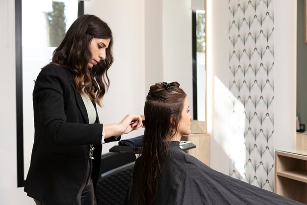 Woman getting treatment at hairdresser shop