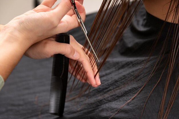 Woman getting treatment at hairdresser shop