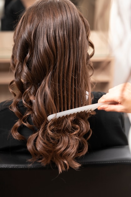 Free photo woman getting treatment at hairdresser shop