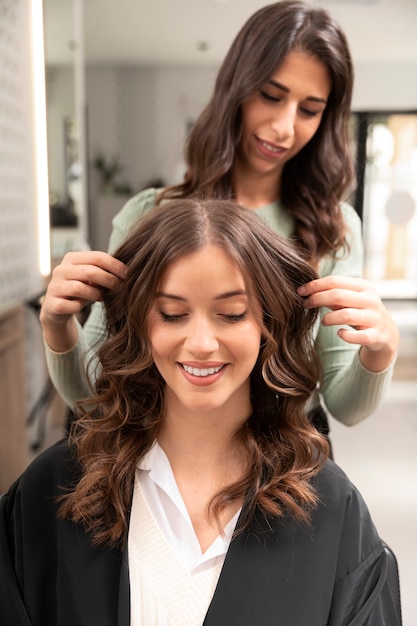 Woman getting treatment at hairdresser shop