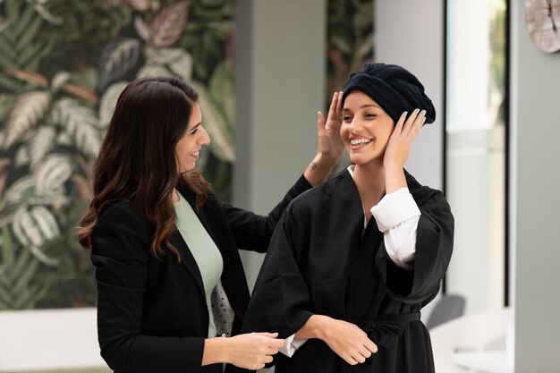 Woman getting treatment at hairdresser shop