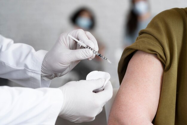 Woman getting vaccine shot by doctor