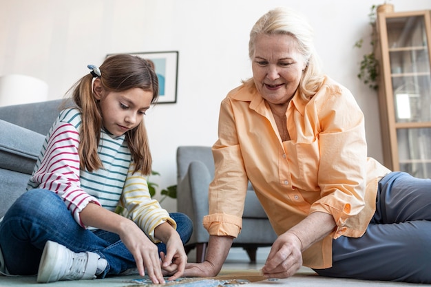 Woman and girl doing puzzle on floor