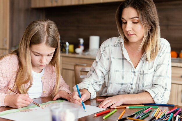 Woman and girl drawing together