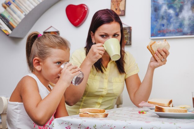 Woman and girl having breakfast