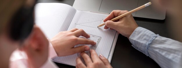 Woman and girl taking notes