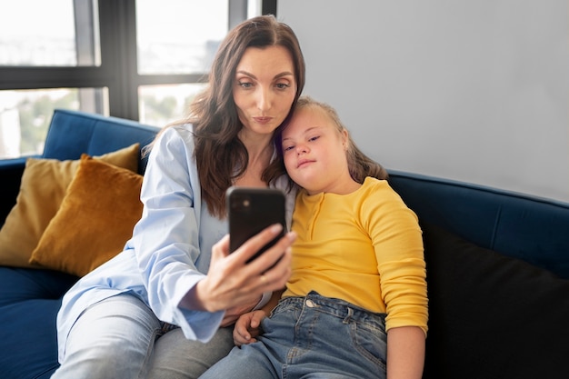 Woman and girl taking selfie front view