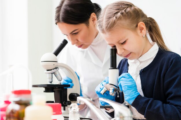 Woman and girl with microscopes