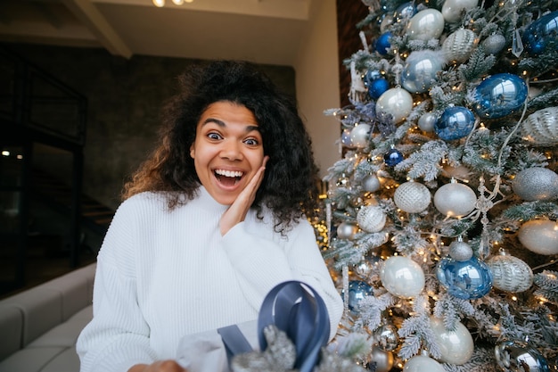 Woman gives a gift to his friend in the camera