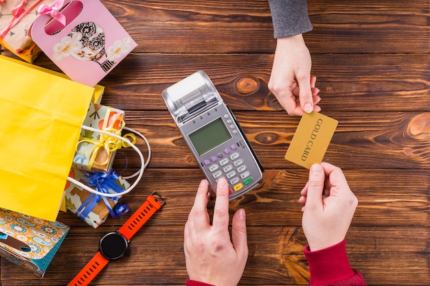 Woman giving bank card to shop assistant for payment