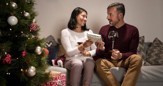 Woman giving a gift to her surprised husband