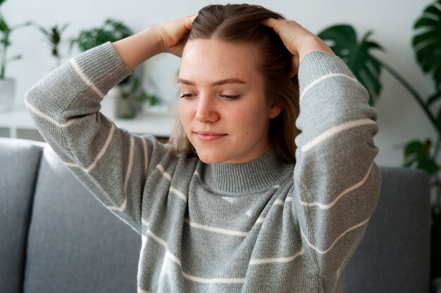 Woman giving herself scalp massage