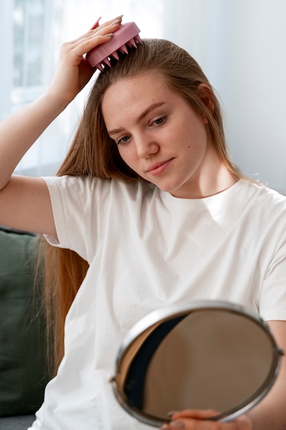 Woman giving herself scalp massage